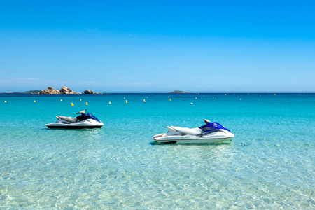 Jet ski mooring in the turquoise water of  Rondinara beach in Corsica Island in France