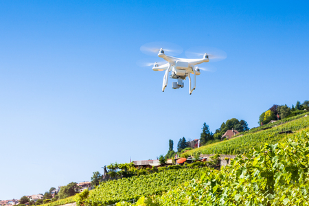 Quadrocopter drone taking aerial photography and videoの写真素材