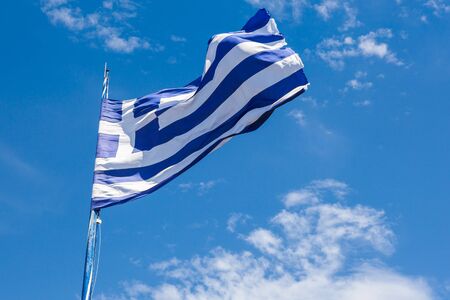 Greek biggest national flag waving in the sky in Keri in Zakynthos (Zante) island in Greeceの写真素材