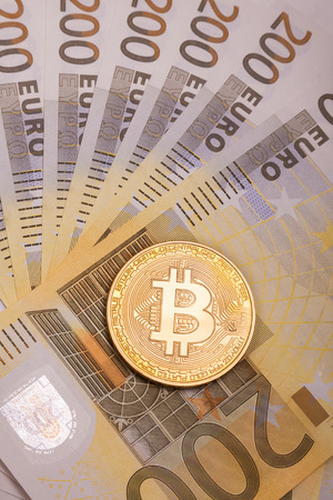 Bitcoin btc crypto currency coin over 200 euro bank notesの写真素材