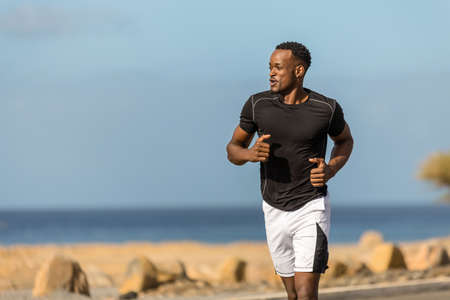 Black african american young man running outdoorの写真素材