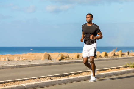 Black african american young man running outdoorの写真素材