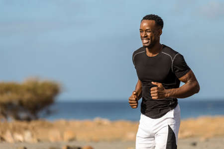 Black african american young man running outdoorの写真素材