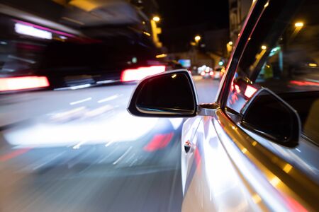 Car light trail while driving in the coty by nightの写真素材