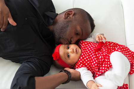 Young african american father holding with her baby girlの写真素材