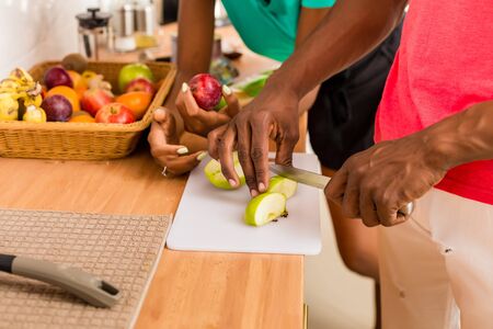 Black African American couple preparing food in the kitchenの写真素材