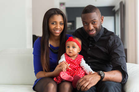 Portrait of a young african american  couple with her baby girlの写真素材
