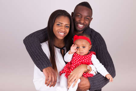 Portrait of a young african american  couple with her baby girlの写真素材