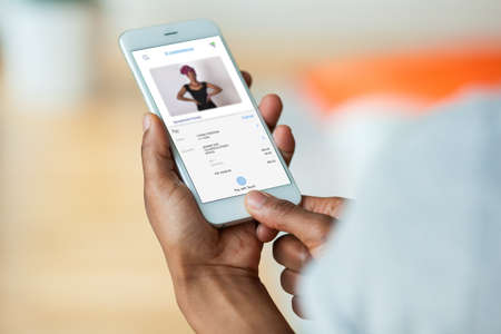 African american person paying an online purchase on her mobile phone smartphone - Black peopleの写真素材