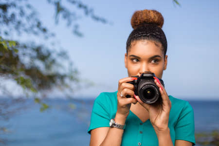 African American woman photographer taking outdoor photos - Black peopleの写真素材