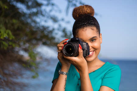 African American woman photographer taking outdoor photos - Black peopleの写真素材