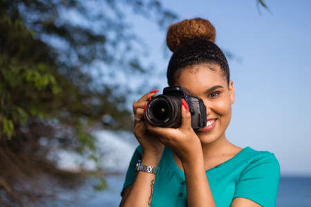 African American woman photographer taking outdoor photos - Black peopleの写真素材