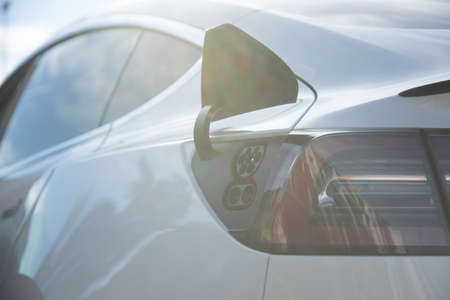 EV electric car pluged charging at a recharge station in the cityの写真素材
