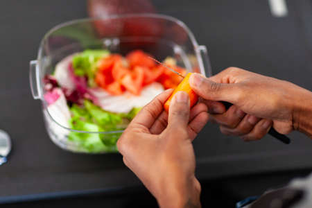African American woman preparing a health sala meal veganの写真素材