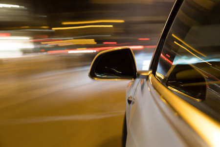 Car light trail while driving in the coty by nightの写真素材