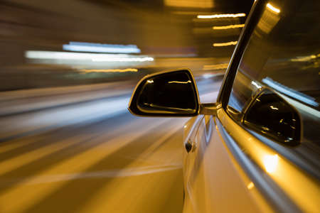Car light trail while driving in the coty by nightの写真素材