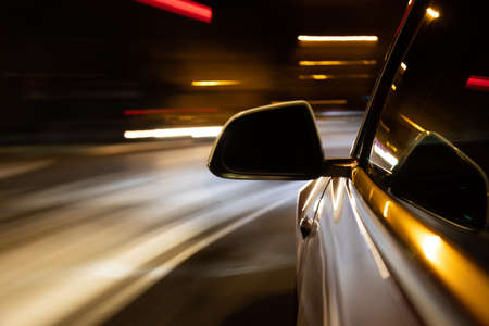 Car light trail while driving in the coty by nightの写真素材