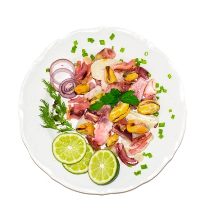 seafood on a plate with lemon and onion isolated on white background. top view. healthy foodの写真素材