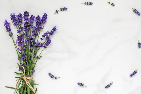 lavender flowers bouquet on white marble table with copy space for your text. top view. flat lay. wedding or womens day backgroundの写真素材