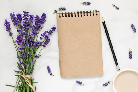 mock up greeting card in frame made of lavender flowers with bouquet and cup of cappuccino for wedding or St. Valentine's Day with place for your text. flat lay. top view. mock upの写真素材