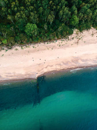 Aerial view of sandy beach, sea and forest on Baltic sea. top view. shot from drone. Landscape photographyの写真素材