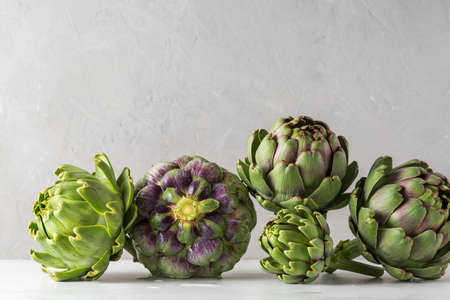 Fresh ripe artichoke on concrete background. Healthy vegan food concept, close upの写真素材