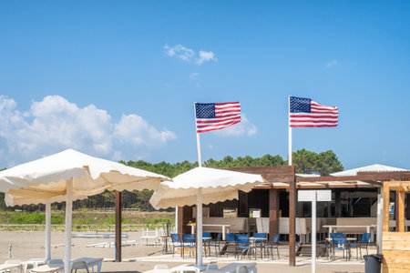 Beach cafe with bar, umbrellas and chairs on a sandy beach. Outdoor restaurant by the seaside. Miami...