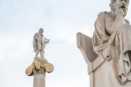 Athens, Greece - 4 December 2023: Apollo column with statue of Socrates from the Academy of Athens, Greece. Selective focus. Focus on Apollon statue.のeditorial素材