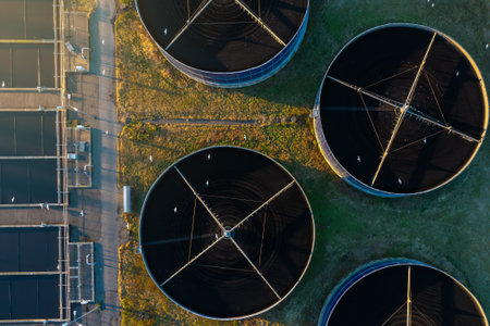 Aerial top down view of sewage treatment plant. Industrial water treatment with round water tanks...