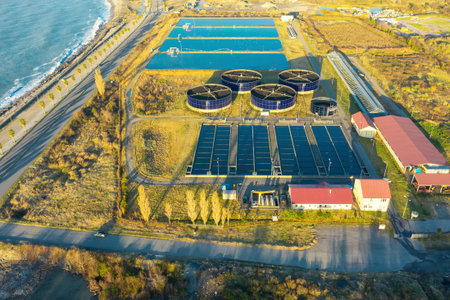 Aerial view of sewage treatment plant. Industrial water treatment with round water tanks for sewage...