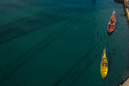 Traditional Portuguese wooden cargo boats rabelo on the Douro River. Top view. Minimalistic artistic shot. Popular touristic destination in Europeの写真素材
