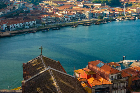 Porto, Portugal view from old town with orange rooftops and small church on the Douro River in sunny day. Popular touristic destination in Europeの写真素材