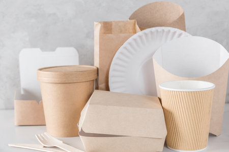 Eco-friendly, biodegradable disposable dishes made of bamboo wood and kraft paper. Cups, cutlery and containers for sustainable delivery and take away food service. Zero waste, reusable tablewareの写真素材