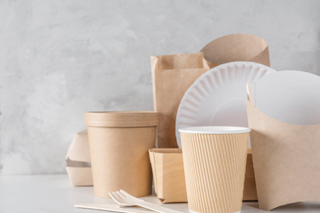 Eco-friendly, biodegradable disposable tableware made of bamboo wood and kraft paper. Cups, cutlery and food containers for sustainable delivery and take away food service. Zero wasteの写真素材