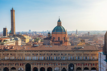 Aerial view of Bologna old town, Emilia Romagna, Italy with Palazzo dei Banchi with arched porticoes and Dome of the Basilica of San Pietro at sunrise and towers. Travel destination in Europeの写真素材
