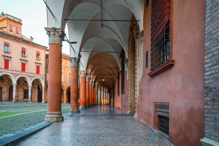 Portico columns on Piazza Santo Stefano in Bologna old town, Emilia Romagna, Italy. Porticoes arched walkway with city square. Travel destination in Europeの写真素材