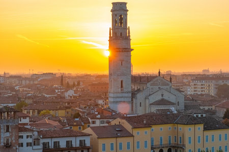 View of Verona old town with bell tower of Verona Cathedral, medieval architecture at sunset,...