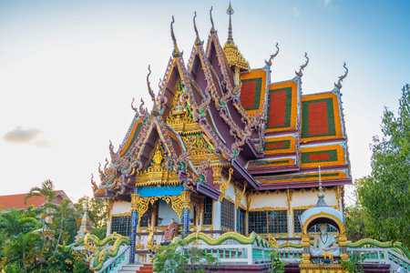 Thai Buddhist Wat Plai Laem temple with intricate golden roof details and dragon statues on Koh Samui island in Thailand. Travel and touristic landmarkの写真素材