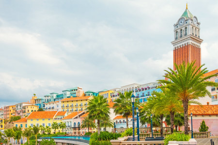 Colorful Mediterranean style buildings with palm trees and tall clock tower in Sunset Town, Phu Quoc island, Vietnam. Italian architecture in Asia. Travel and touristic destinationの写真素材