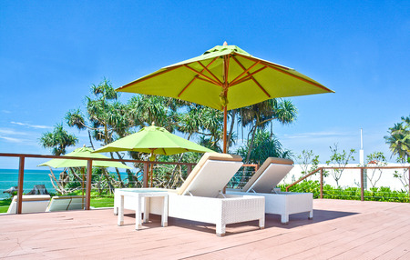 Beach Umbrella And Sunbath Seats In A Tropical Beach Hotel That Located In Costal Area Negambo, Sri Lankaのeditorial素材
