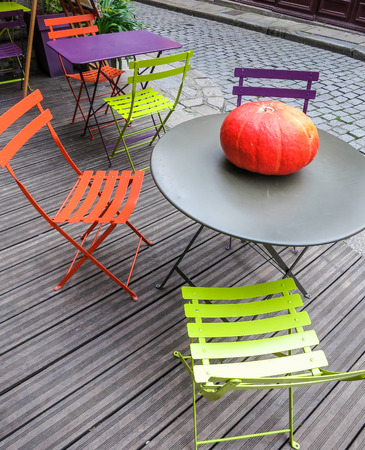 Pumpkin on round table on wooden patioの写真素材