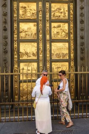 People, tourists in front of the doors of Paradise in Battistero di San Giovanni, Florence, Italy.のeditorial素材