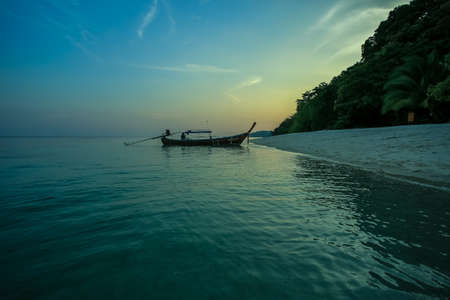 Longtail boat in the sea at sunset, Koh Kood, Thailandの写真素材