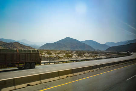 Truck driving on the highway in the desert of the United Arab Emiratesの写真素材