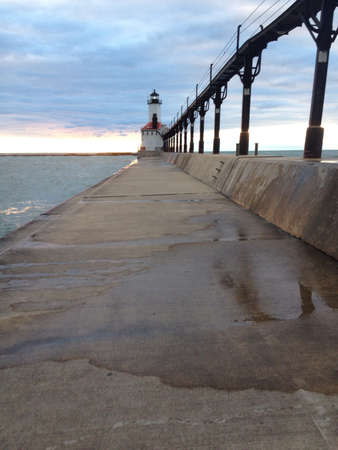 A view of a lighthouse from the walkway on a warm summer day. の素材