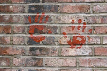 Dry marks of human palms on the brick wallの写真素材