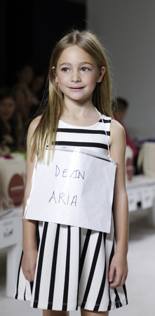 New York, NY, USA - October 19, 2014: A model walks the runway rehearsal during the Aria Children's Clothing collection preview at petitePARADE/Kids Fashion Week at Bathhouse Studios, Manhattanのeditorial素材