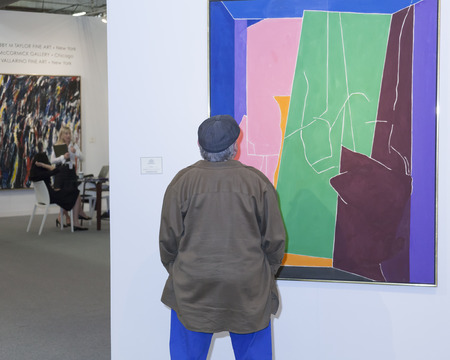 New York, NY, USA - May 16, 2015: Visitors view artworks at Art Miami New York, the international contemporary and modern art fair at Pier 94, Manhattan. Paintings, sculpture, installation from about 1200 artists from over 50 countries presented by 100 leのeditorial素材