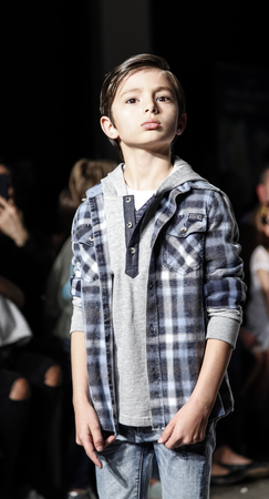 New York, NY, USA - March 12, 2016: A Model walks the runway for 7 for all Menkind collection at petitePARADE / Kids Fashion Week New York at Spring Studios, Manhattan.のeditorial素材