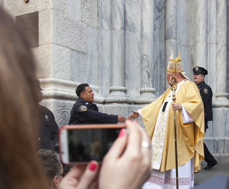 New York, NY, USA - March 27, 2016: Archbishop of New York Cardinal Dolan greets worshipers and...